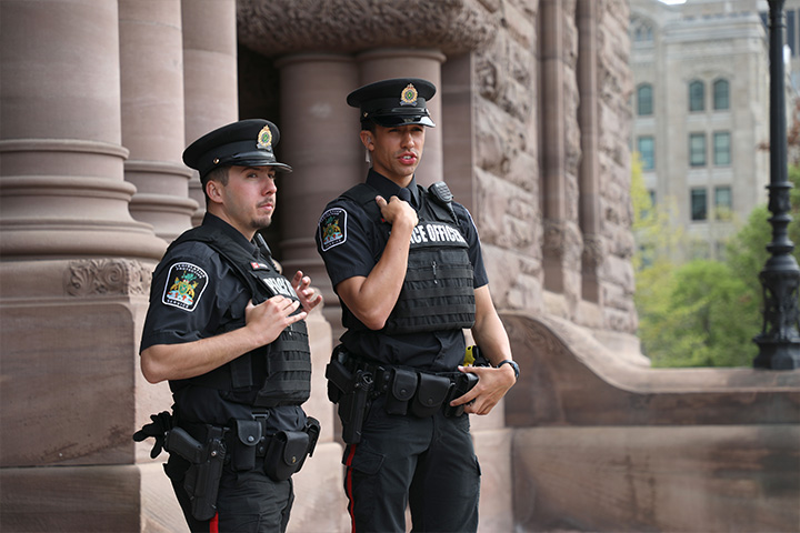 two Legislative Protective Service officers standing outside Legislative Building