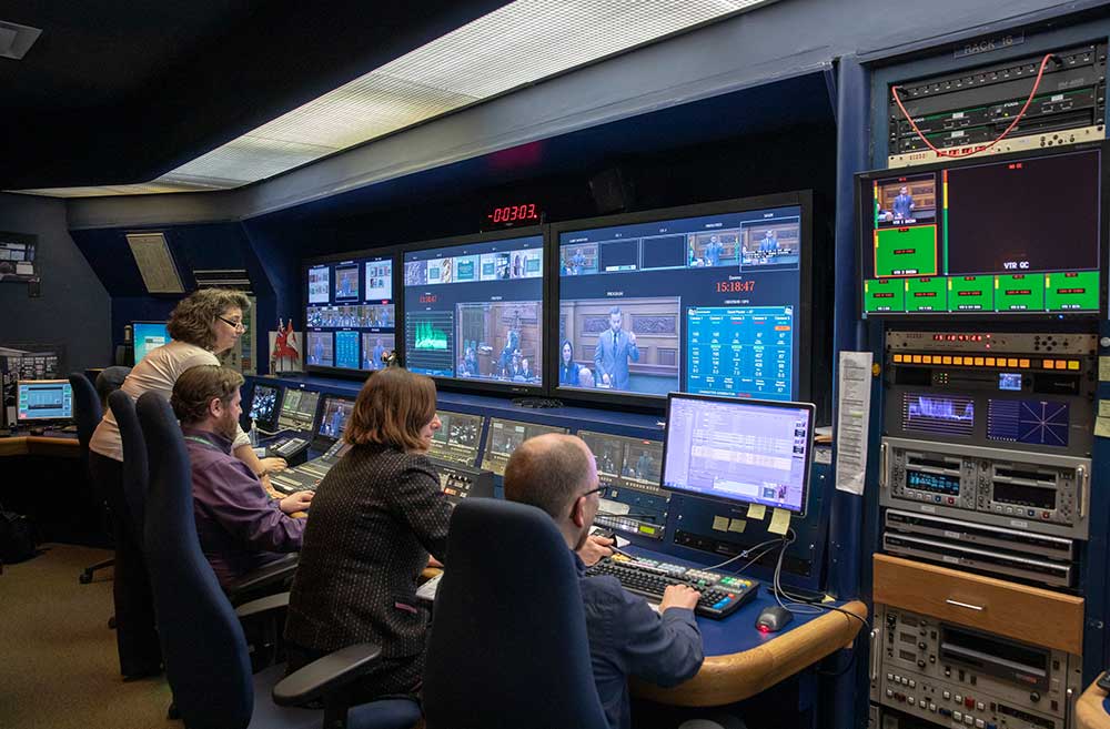 four broadcast operators in control room
